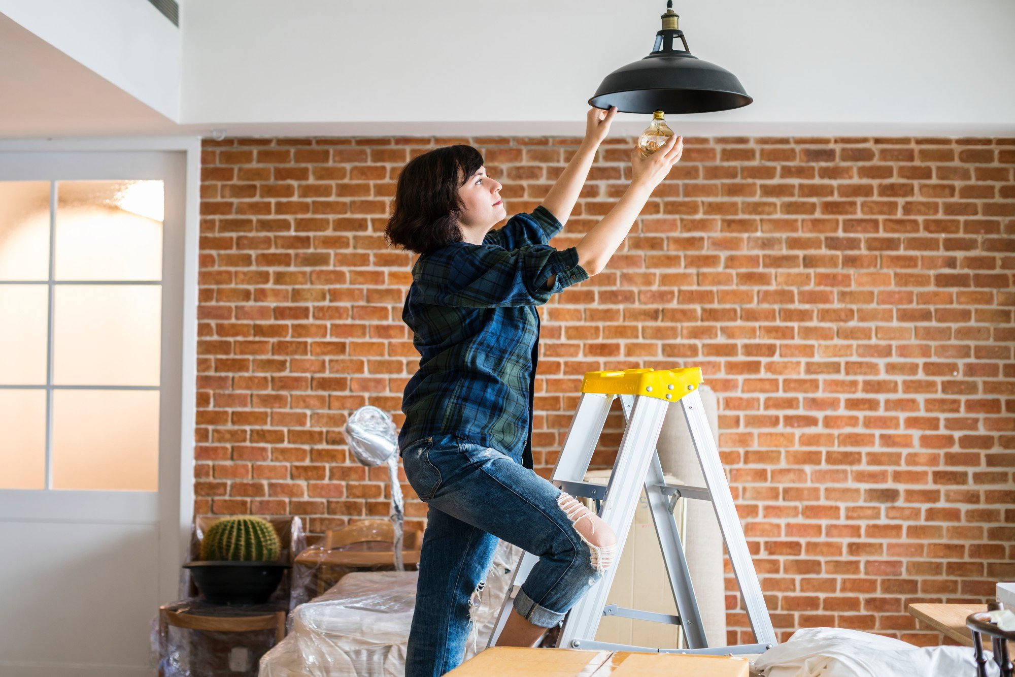 Woman fixing a light bulb