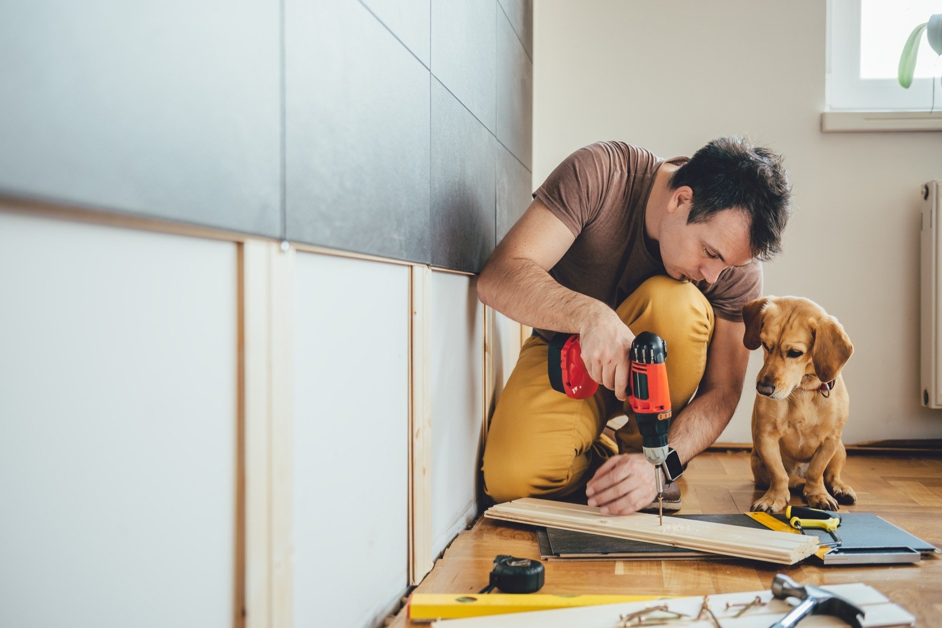 Man working on a renovation at home with a tool bought in a tool store in texas